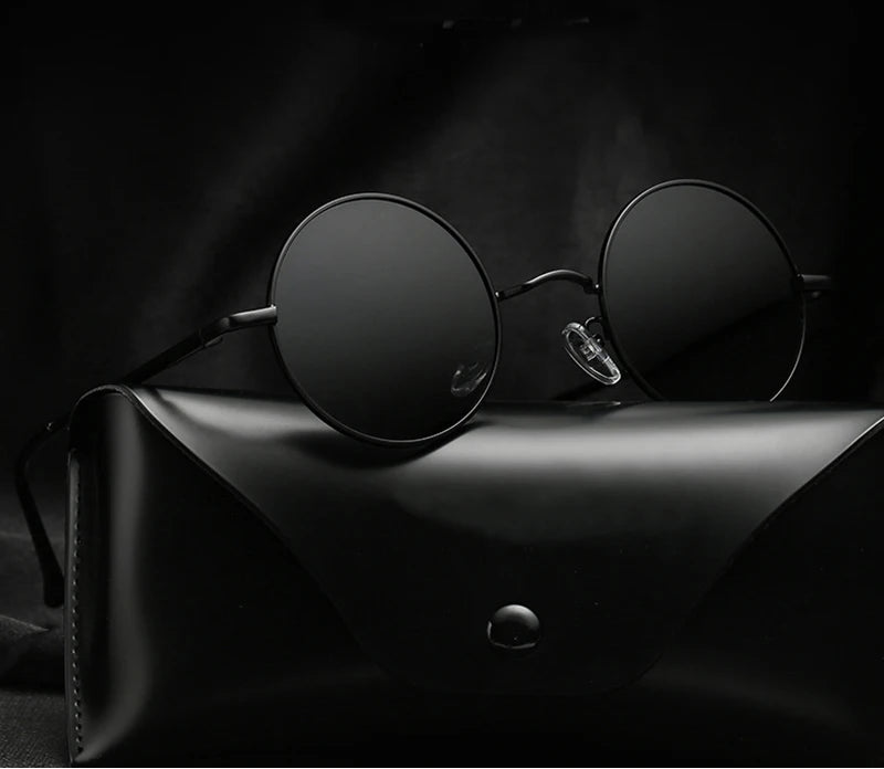 Black round sunglasses on a dark surface with 'Ruo Bo' branding.