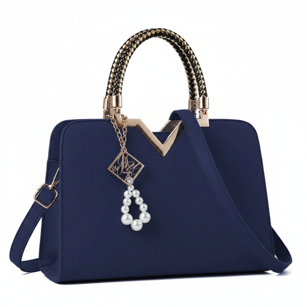 Navy blue handbag with decorative handle and charm on a white background